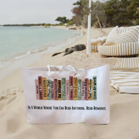 The weekender bag is displayed standing upright on the beach next to beach towels.
