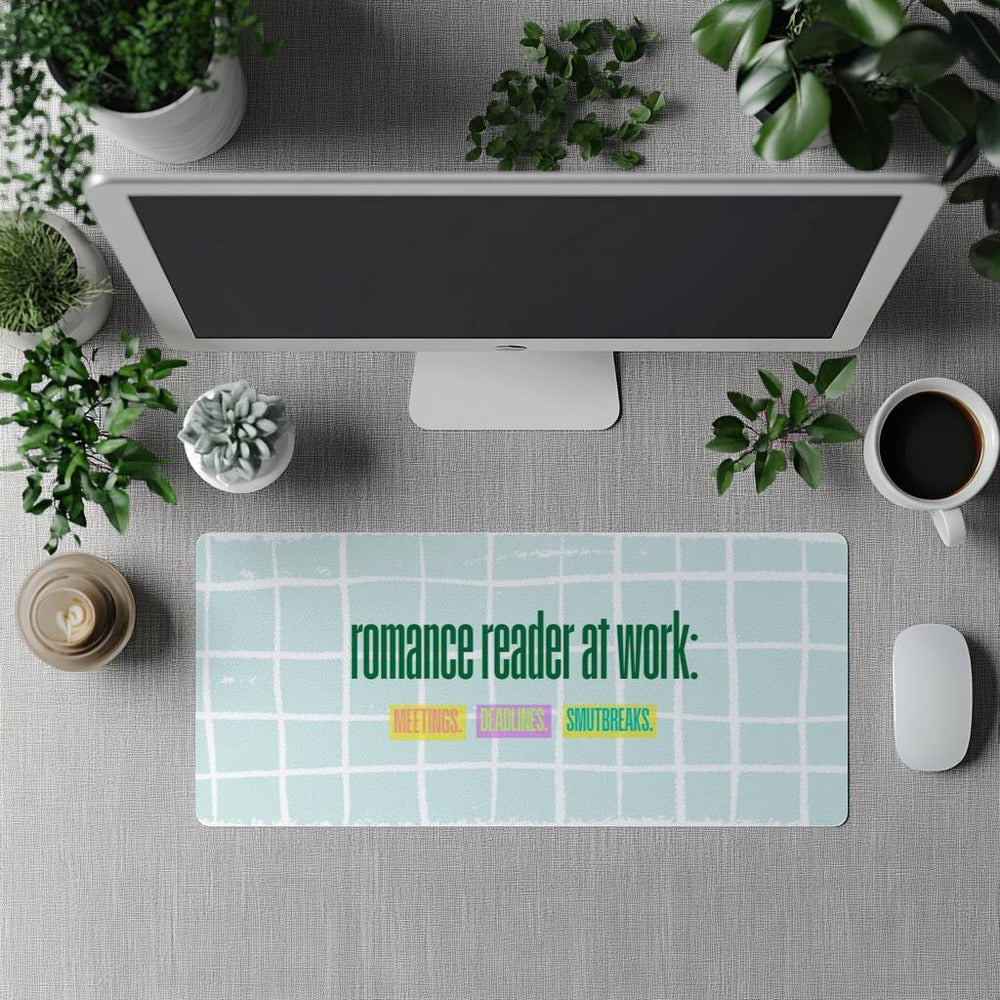 The desk mat is displayed in front of a standing full-size computer screen for use with a separate keyboard.

