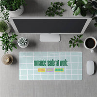 The desk mat is displayed in front of a standing full-size computer screen for use with a separate keyboard.

