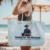 The tote bag is being modeled by a woman in a green tank top, standing on the beach, wearing it over her shoulder.

