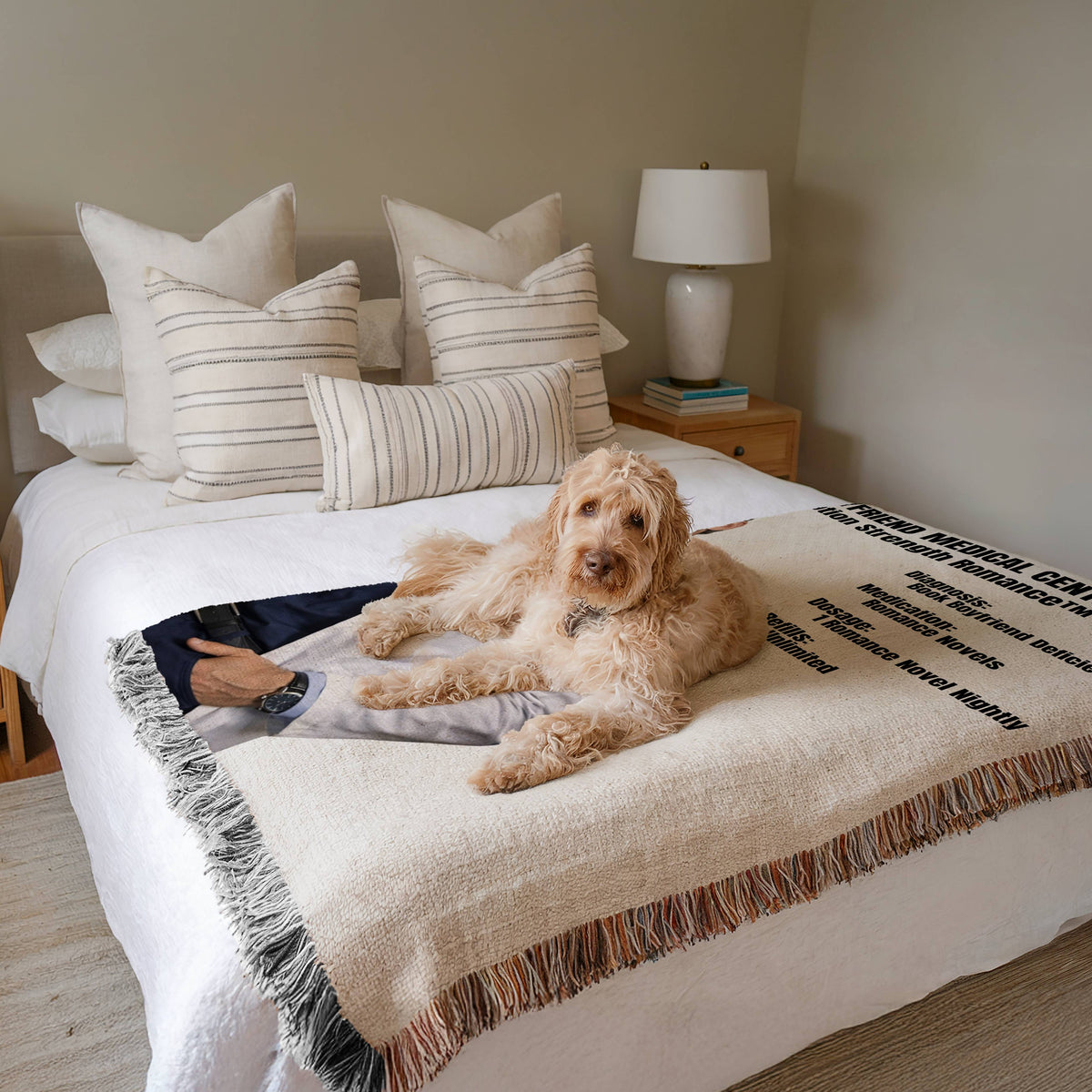 Prescription Strength Romance woven blanket draped across a bed with a dog resting on top