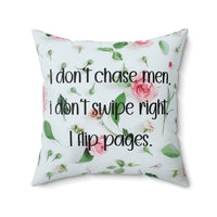 Square pillow with white background, small floral print, and text: “I don’t chase men. I don’t swipe right. I flip pages.”