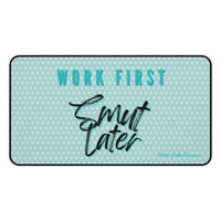 Light green desk mat with lighter green polka dots. Large teal block letters outlined in black read “WORK FIRST” above black brush script with a teal shadow that says “Smut Later.”