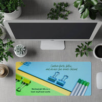 The desk mat is displayed in front of a standing full-size computer screen for use with a separate keyboard.

