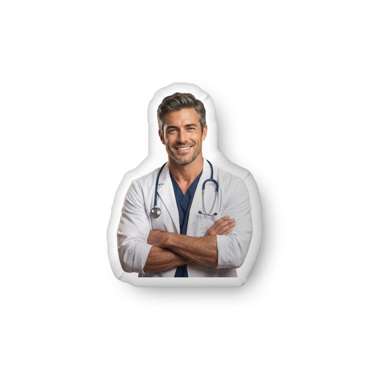 ProducCustom-shaped decorative pillow featuring The Doctor, a handsome medical romance book boyfriend with salt-and-pepper hair, light stubble, and a confident smile, wearing a white lab coat with a stethoscope and folded arms. Shown as a standalone pillow against a neutral background. This medical romance book boyfriend pillow is available in three sizes (10" x 10", 16" x 16", and 22" x 22").t mockup