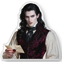 Custom-shaped gothic vampire book boyfriend decorative pillow featuring a pale, dark-haired aristocratic man holding a sealed letter, wearing a burgundy patterned vest and white shirt against a transparent background. Available in three sizes: 10″ × 10″, 16″ × 16″, and 22″ × 22″.