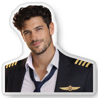 Custom-shaped decorative pillow featuring The Pilot, an aviation romance book boyfriend with dark hair, light stubble, and a confident smile, wearing a commercial pilot uniform with captain’s stripes and loosened tie. Shown as a standalone pillow against a neutral background. This aviation romance book boyfriend pillow is available in three sizes (10" x 10", 16" x 16", and 22" x 22").