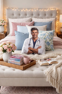 The Doctor medical romance book boyfriend pillow styled on a cozy bed surrounded by decorative throw pillows, soft blankets, romance novels, and warm bedroom lighting. The custom-shaped pillow features a handsome doctor in a lab coat with a stethoscope, creating a comforting, bookish bedroom setting designed for romance readers.